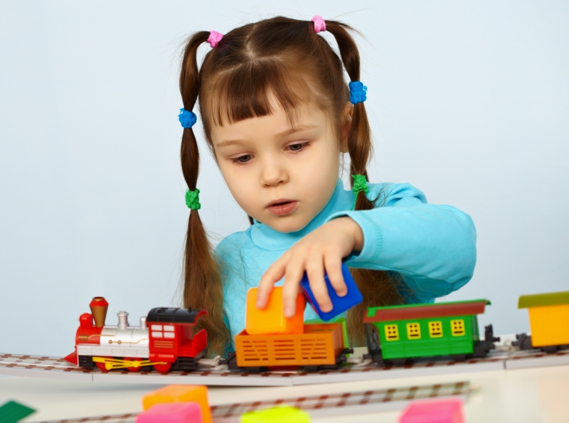 2677071-little-girl-preschooler-playing-with-toy-railway